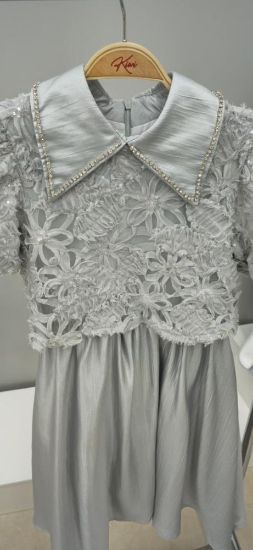 صورة فستان سماوي أنيق مزين بالتل على الصدر